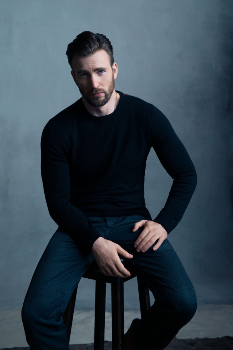 Chris Evans sentado en un banco posando para una fotografía