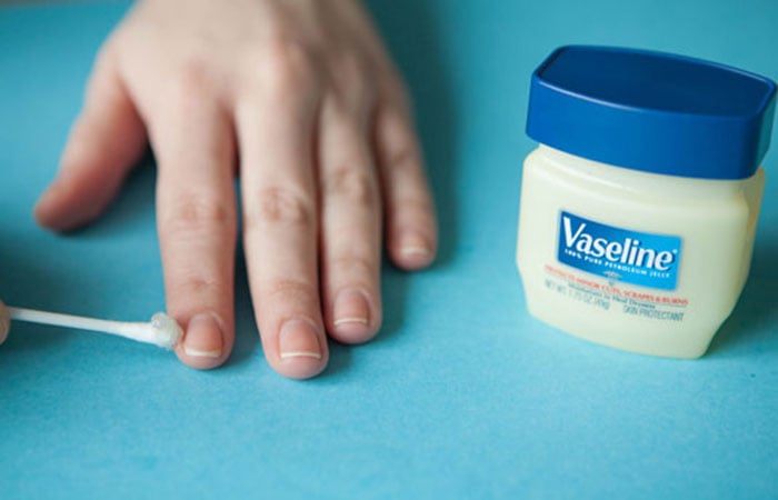 colocando vaselina sobre las uñas 