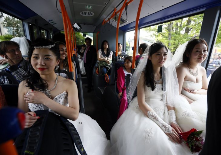 mujeres vestidas de novias sentadas en un autobús público 