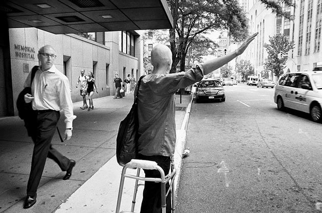 A passerby stares as Jen hails a cab.