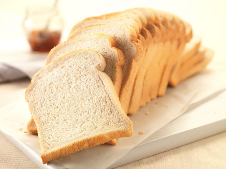 barra de pan cortada en rebanadas y colocadas sobre un plato 