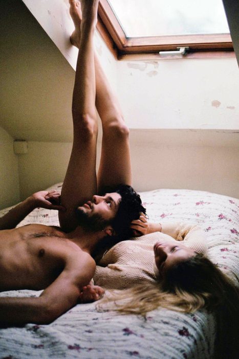 Chica en la cama platicando con un hombre 