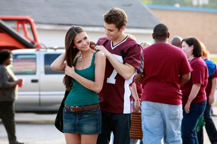 stefan poniéndole un collar en el cuello a elena de la serie the vampire diaries