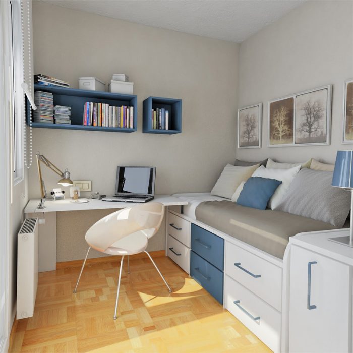 habitacion de una persona con tonalidades en azul y gris que tambien tiene un escritorio al lado de la cama 