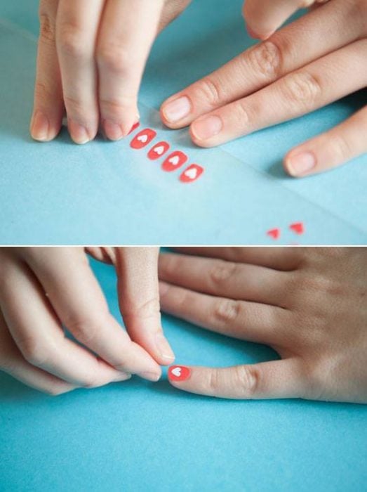 mujer sacando estampas de un papel para colocarlas en sus uñas 