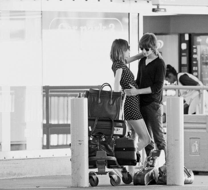 Pareja de novios en el aeropuerto abrazados 
