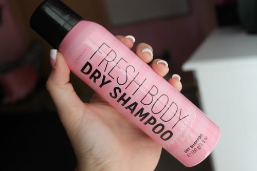 Chica sosteniendo una botella de shampoo 