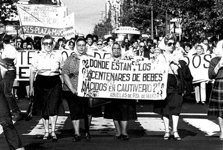 Asociación de las abuelas de la plaza de mayo marchando para exigir justicia 