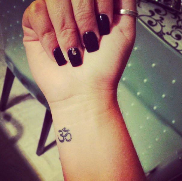 Chica con el tatuaje del símbolo ohm 