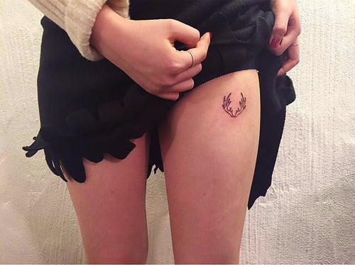 Pierna de una chica con un tatuaje de un siervo 