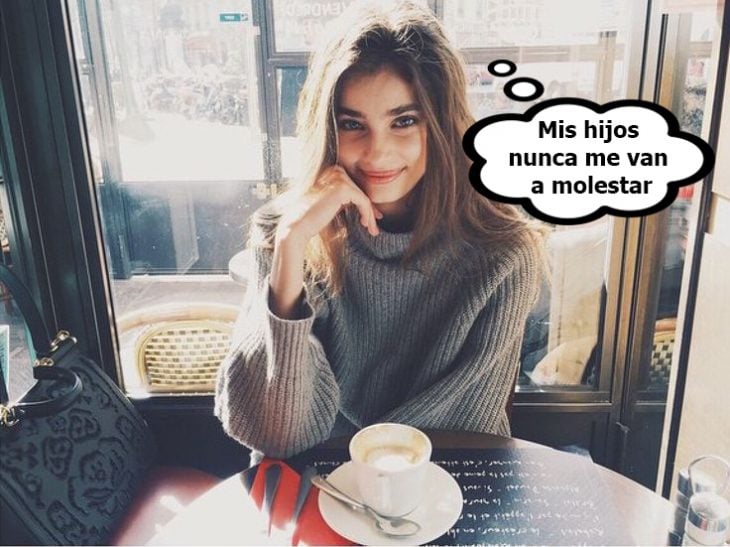 Chica sentada en un restaurante tomando café 