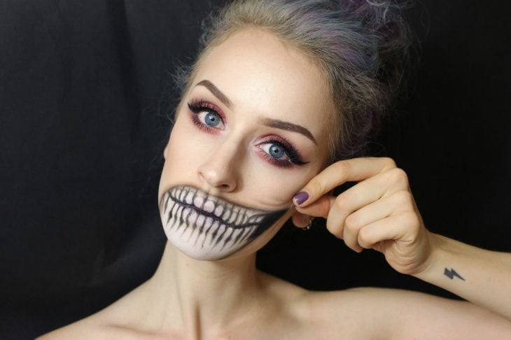 Chica con maquillaje para halloween Con la boca en forma de calavera 