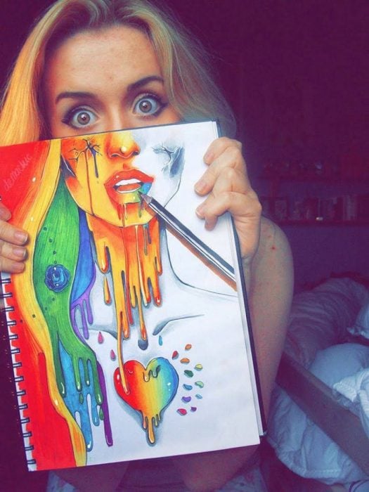 Chica con un dibujo con los colores del arcoíris 