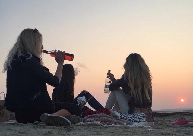 Chicas bebiendo en la playa 