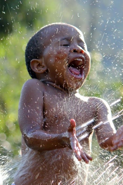 niño jugando con agua