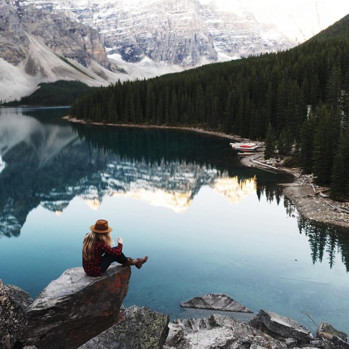 Chica reflexionando frente a un lago 