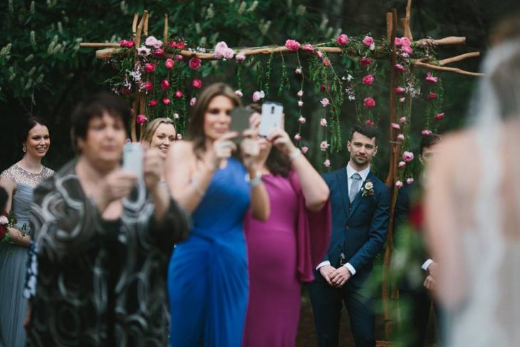 Personas tomando múltiples fotos de una boda siendo los invitados 