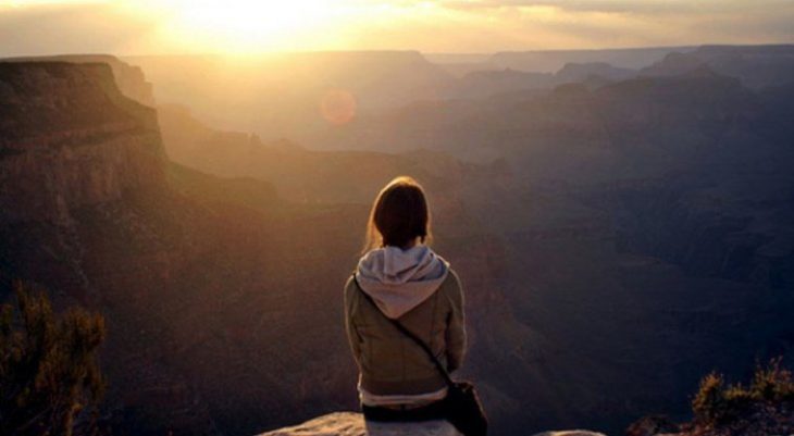 chica observando el horizonte en la montaña