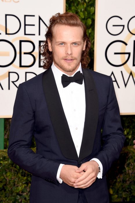 Sam Heughan posando en la alfombra roja de los globos de oro 