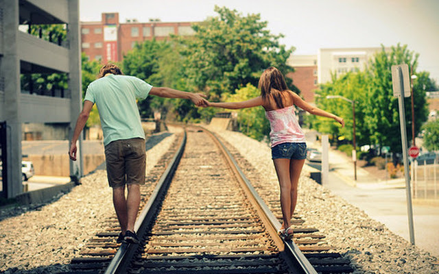 pareja caminando vías del tren