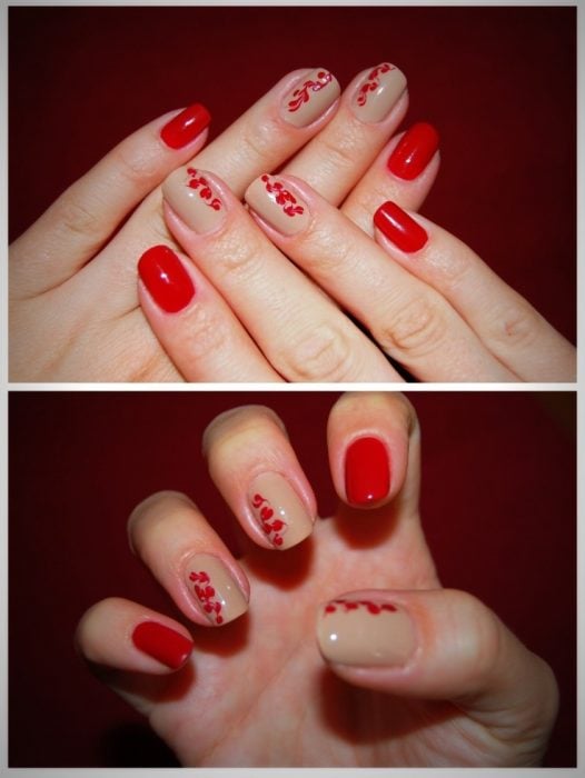 Uñas de color rojo con diseños de pétalos de flores en color rojo