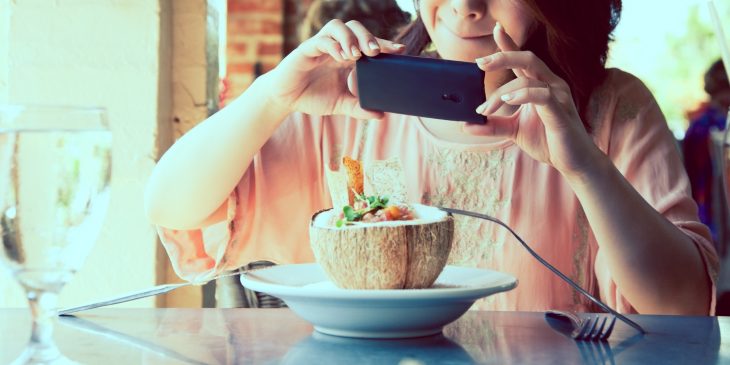 chica fotografiando su comida