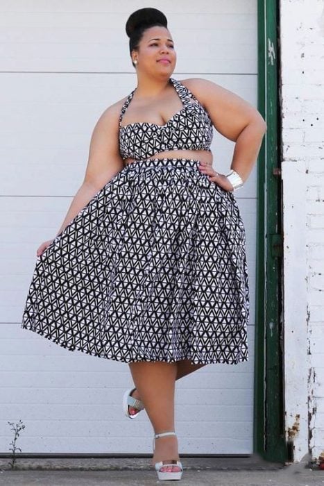 Chica curvi usando un crop top con falda en un diseño de estampados de bolitas