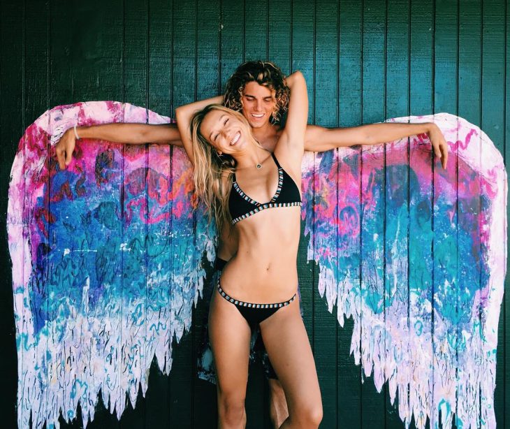 Jay Alvarrez y Alexis Ren Pareja de novios que viajan al rededor del mundo sobre unas alas pintadas en una pared 