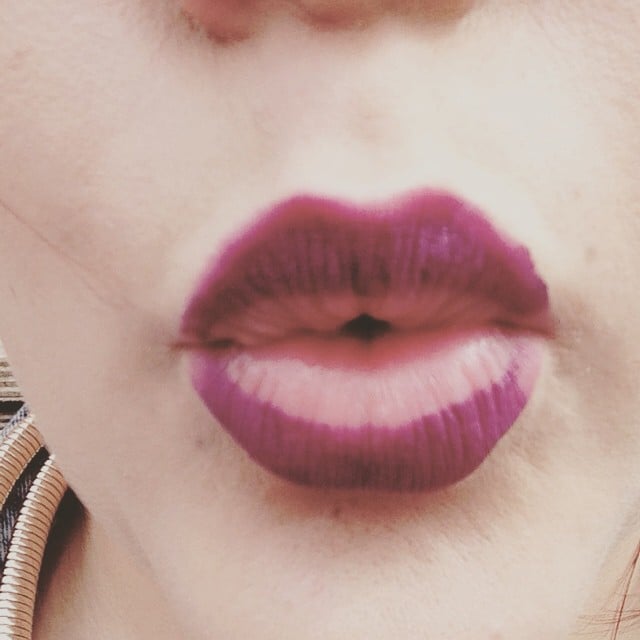 Chica con la mitad de los labios pintados con lipstick 