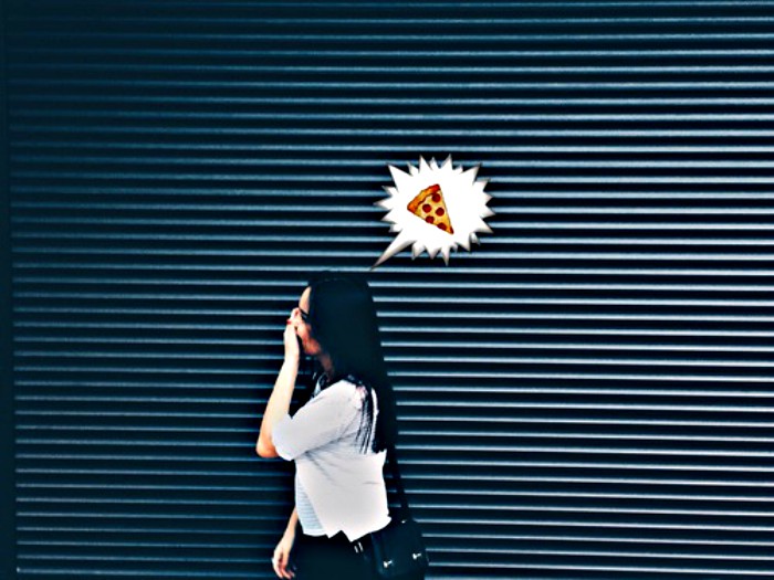 Mujer que va caminando y pensando en una pizza