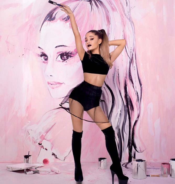 chica con botas altas y falda negra atras pintura rosa ariana