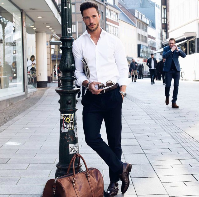 hombre junto a un poste y camisa blanca 