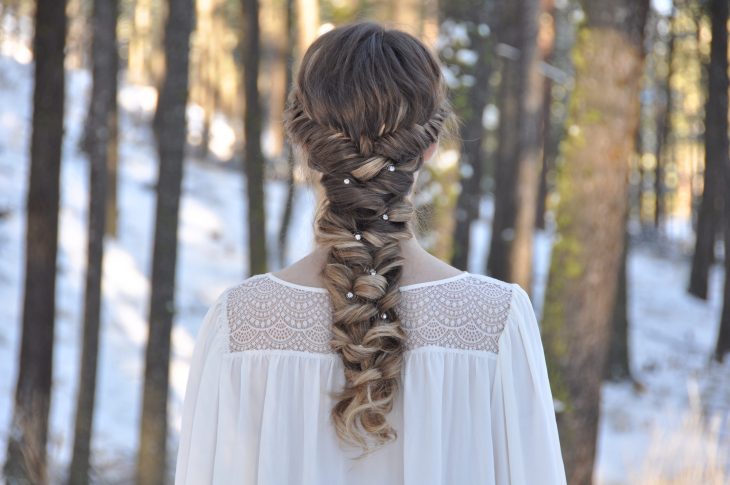 Chica luciendo una trenza con destellos de piedras en su cabello 