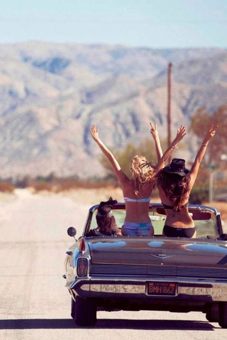 Amigas en una carro viajando por carretera 