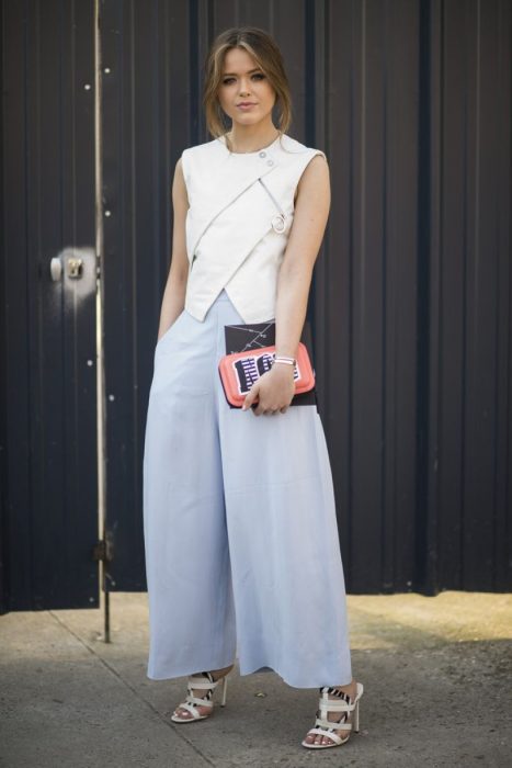 Chica usando unos pantalones holgados y una blusa en color blanco 