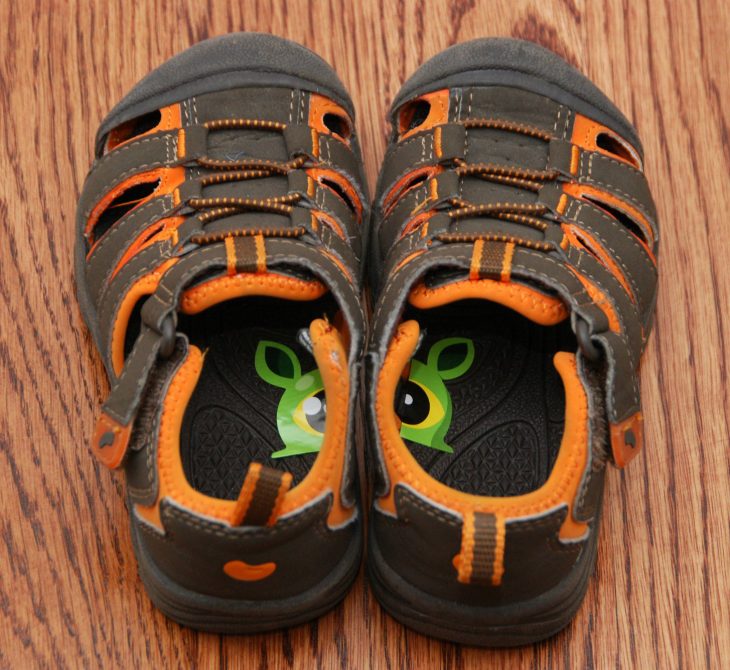 Zapatos de un niño con distintas calcomanías 