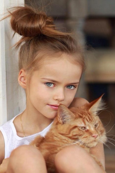 Kristina Pimenova cuando era pequeña, abrazando a su gato. 