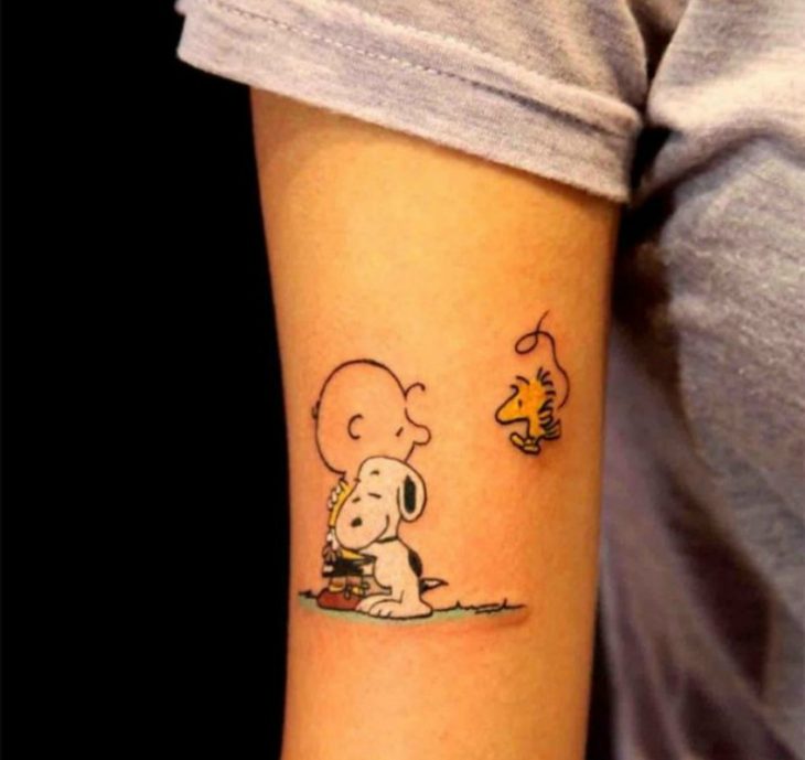 tatuaje de charlie brown en el brazo 