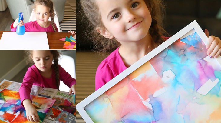 Niña haciendo una obra de arte con papel de colores. 