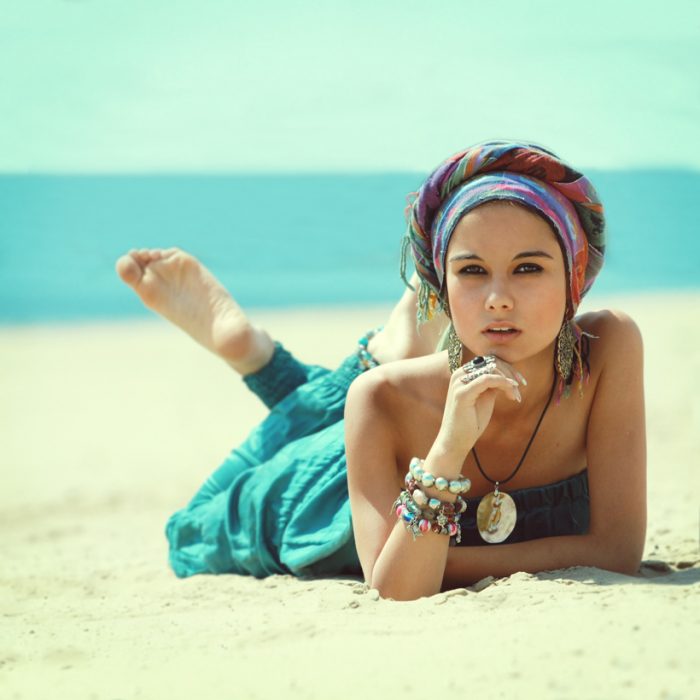 Muchacha en la playa, usando accesorios. 