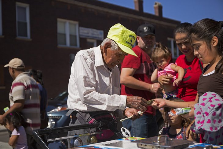 Fidencio Sanchez sells popsicles, Monday, Sept.12, 2016, in Chicago. What began as a small effort to help out Sanchez, who was spotted pushing a paleta cart and selling the frozen treats to help pay bills has brought in more than $250,000 in just four days. (Alyssa Pointer/Chicago Tribune via AP)