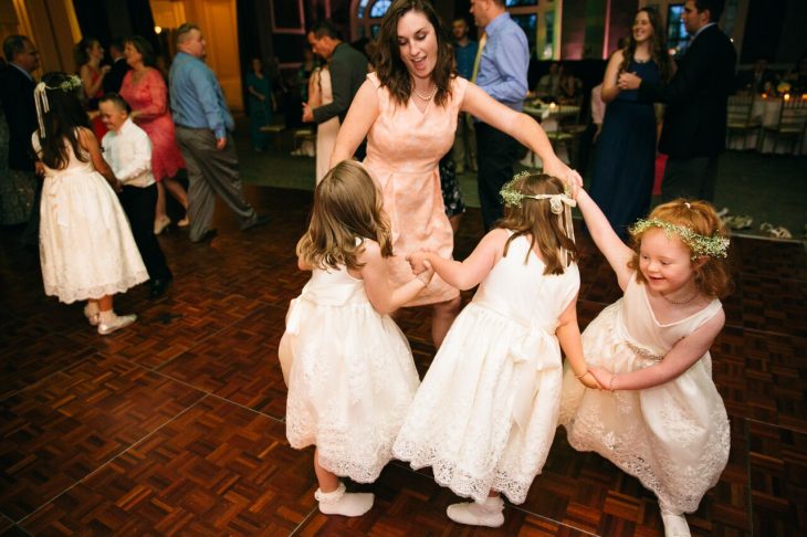 mujer con vestido bailando con niñas 