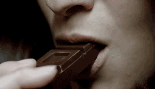 Mujer masticando chocolate. 