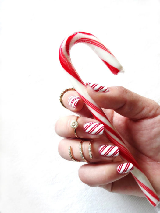 Decoración de uñas navideñas con forma de bastones de azúcar