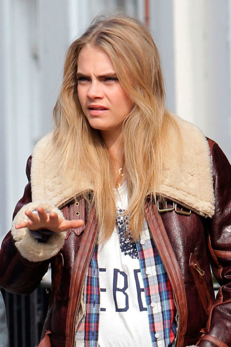 cara delevinge caminando en la calle