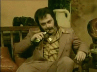 hombre sentado con bigote destapa cerveza gif 