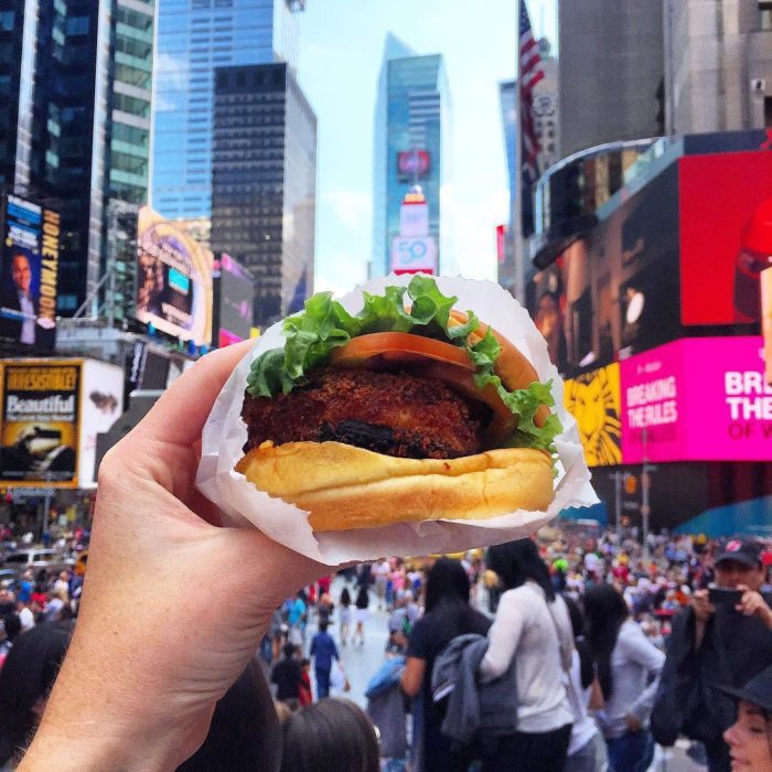 chica comiendo hamburguesas en new york