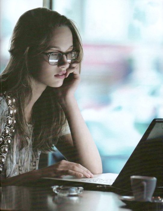 chica con lentes pasando su tiempo con su computadora editada