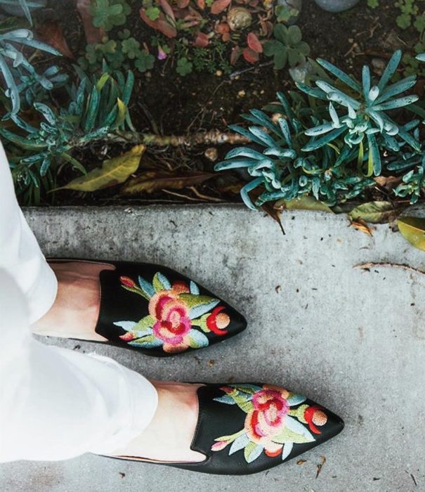 pies de mujer con zapatos bordados con flores 