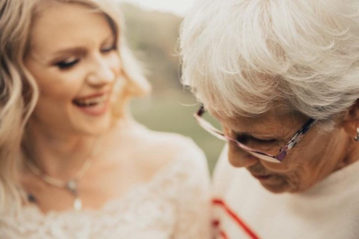 abuela mirando a su nieta usar su vestido 